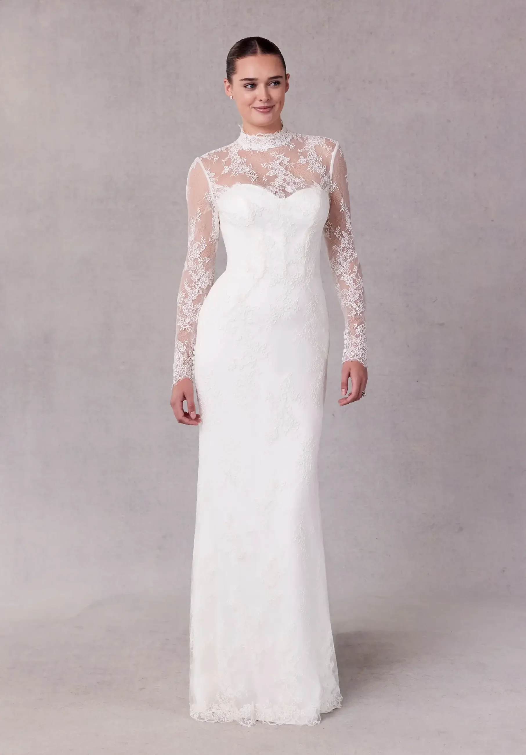 model is wearing a high neckline lace wedding gown