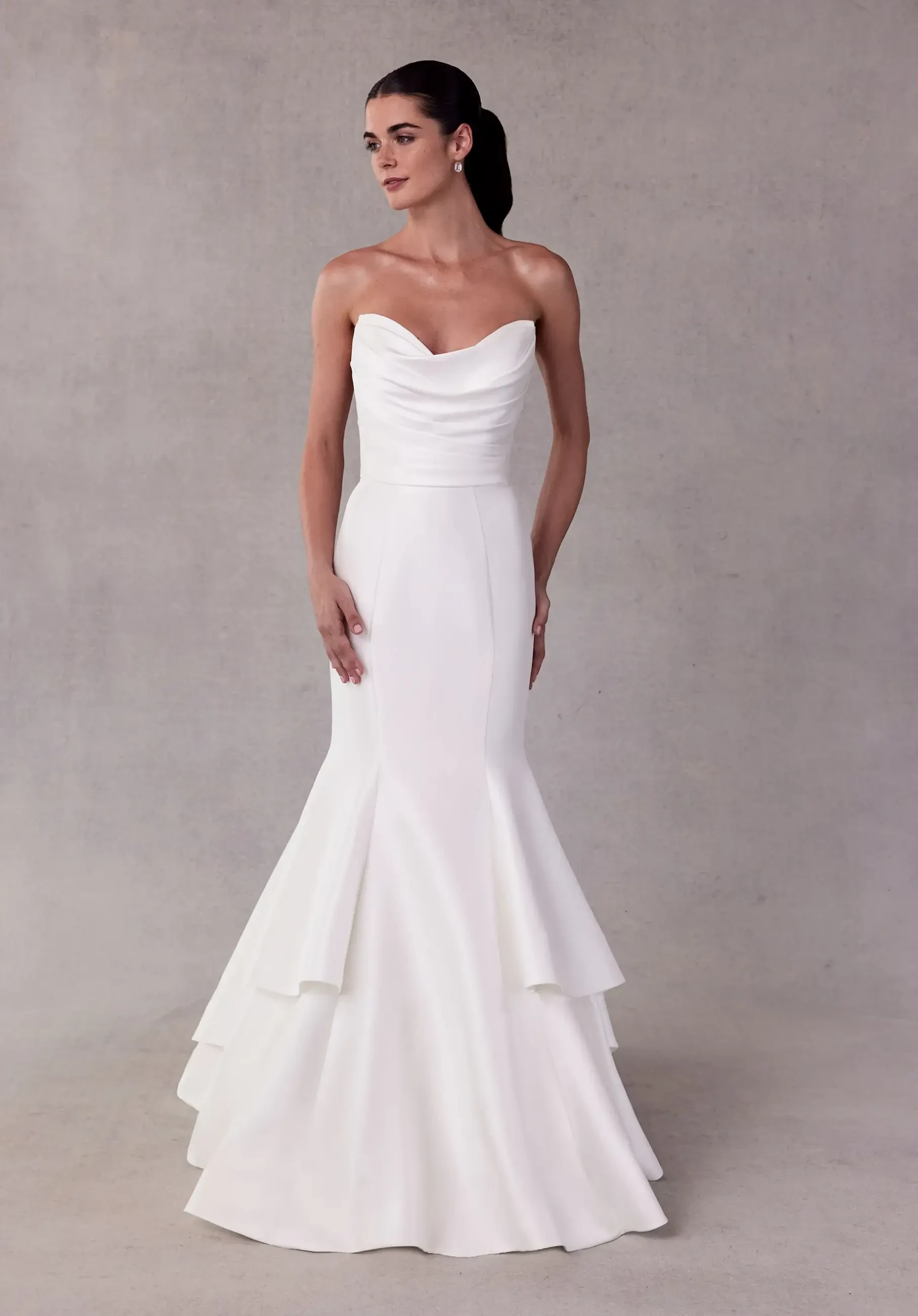 model is wearing a strapless minimalist mermaid wedding dress