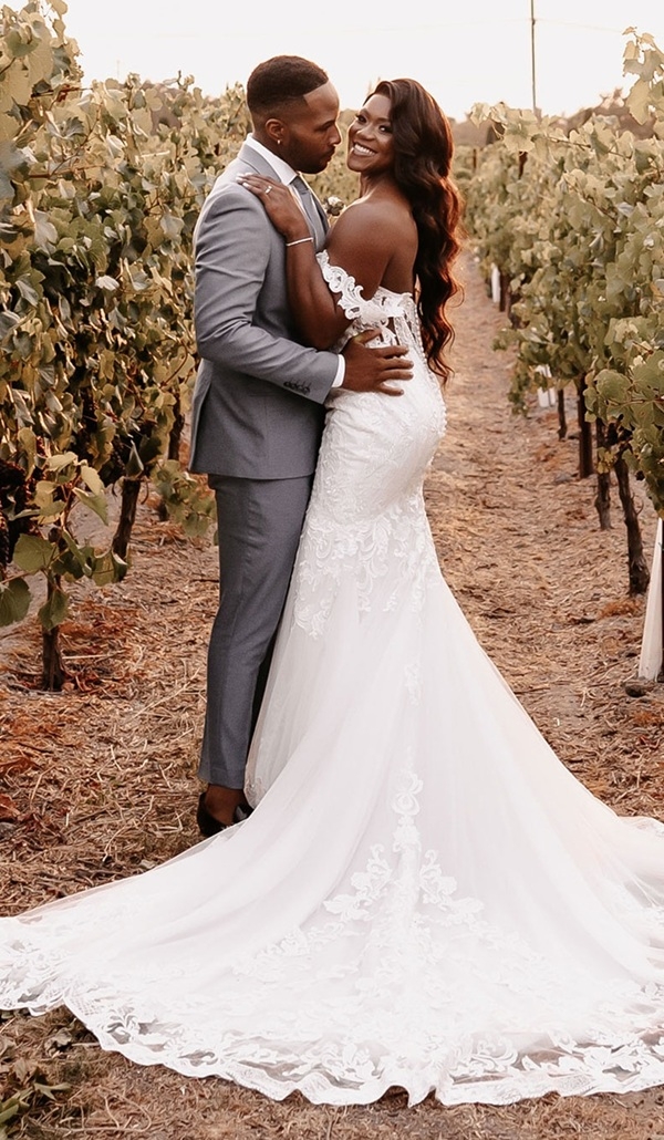 Photo of the real bride and groom posing in the garden