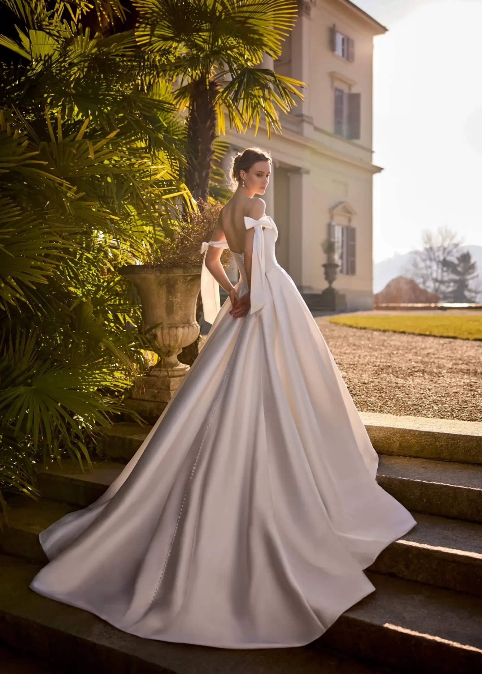 model is wearing an off the shoulder a-line wedding dress