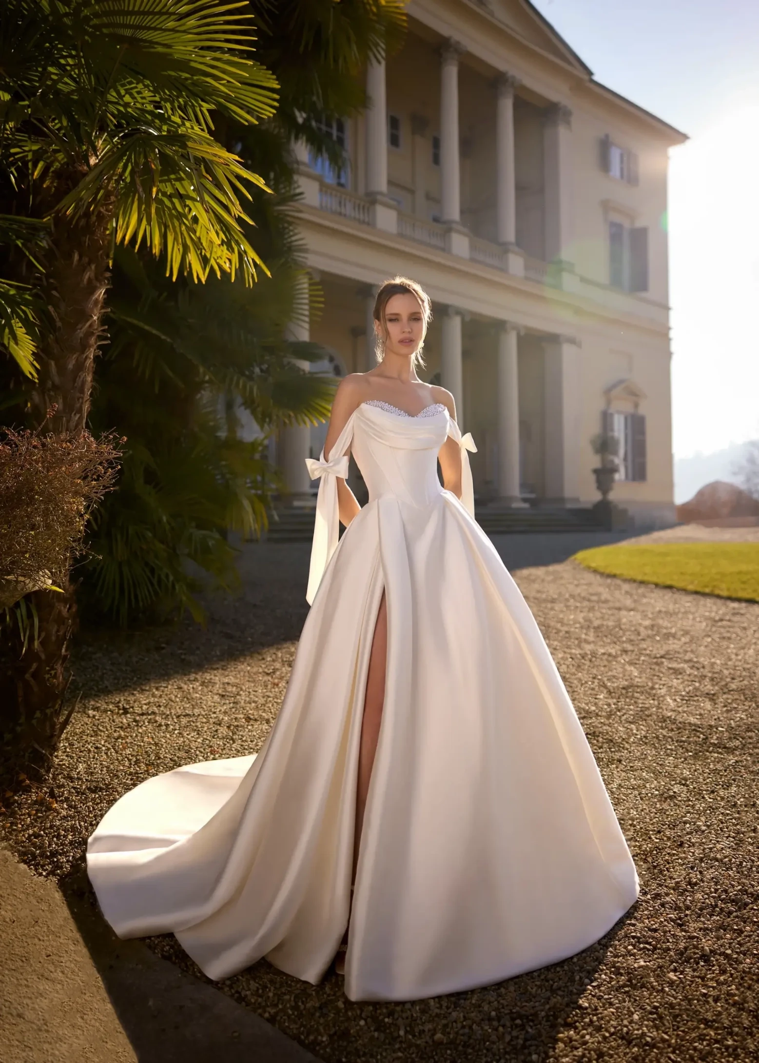 model is wearing an off the shoulder a-line wedding dress